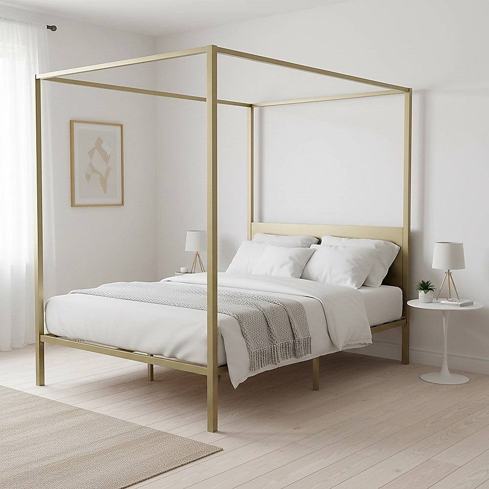 Light wood four-poster double bed frame with canopy, showing white bedding