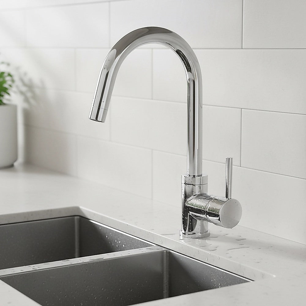 Chrome mixer tap faucet with curved spout and round lever mounted on sink