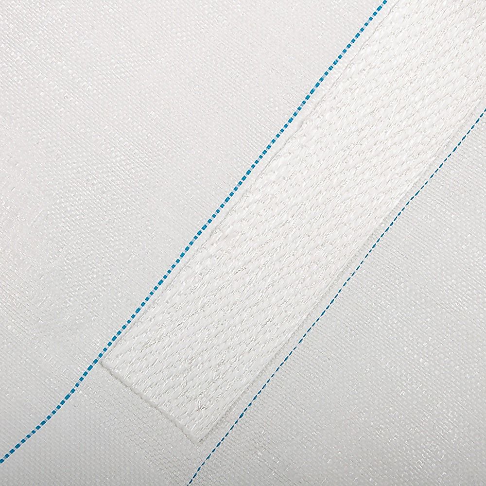 Close-up of white FIBC bulk bag fabric panel with blue stitching seam