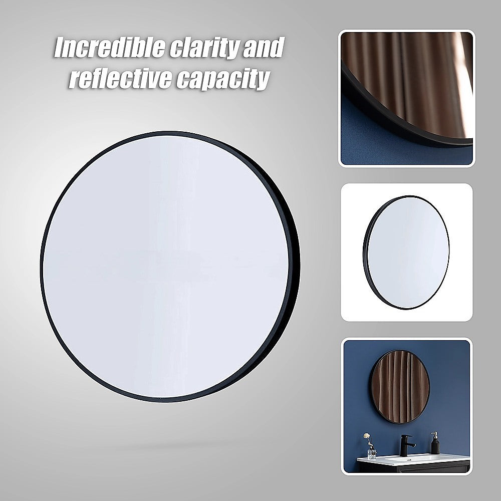 Round wall mirror with dark rim and reflective glass, close-up view.