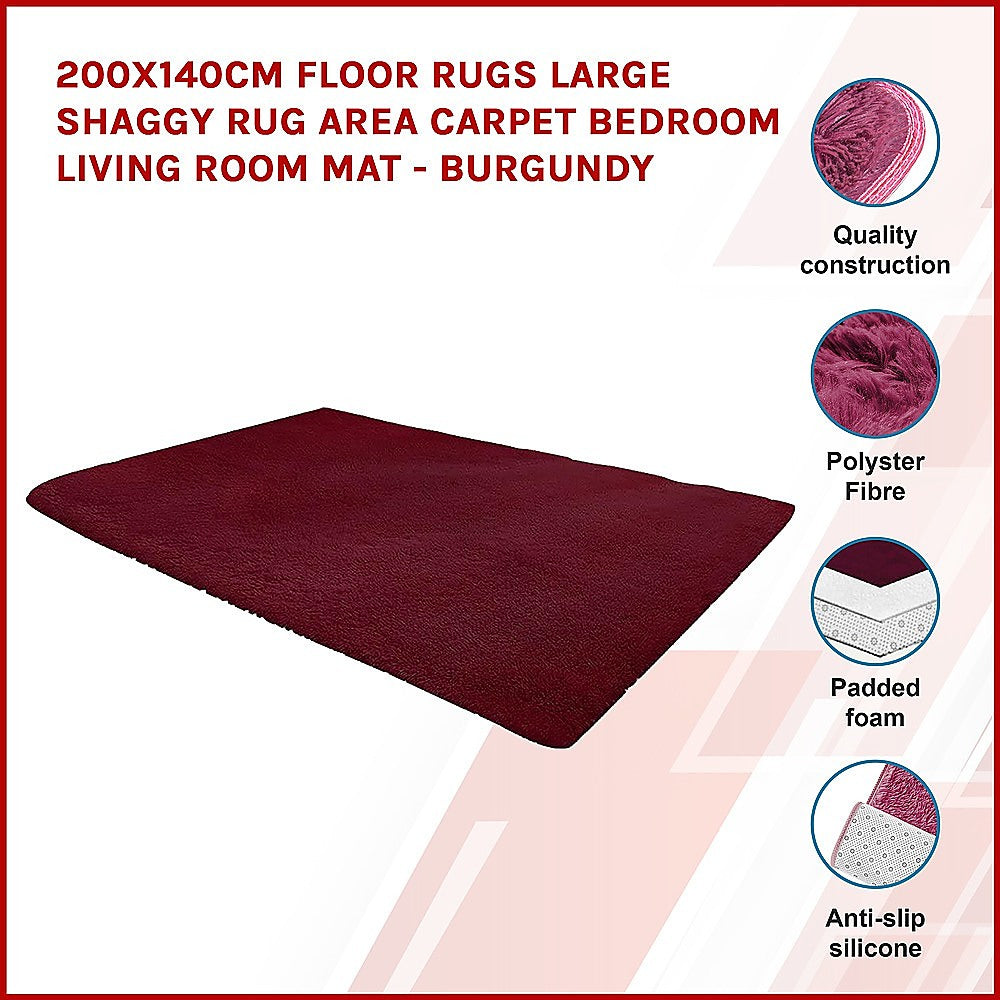 Burgundy shaggy area rug, rectangular; side edge and pile texture shown