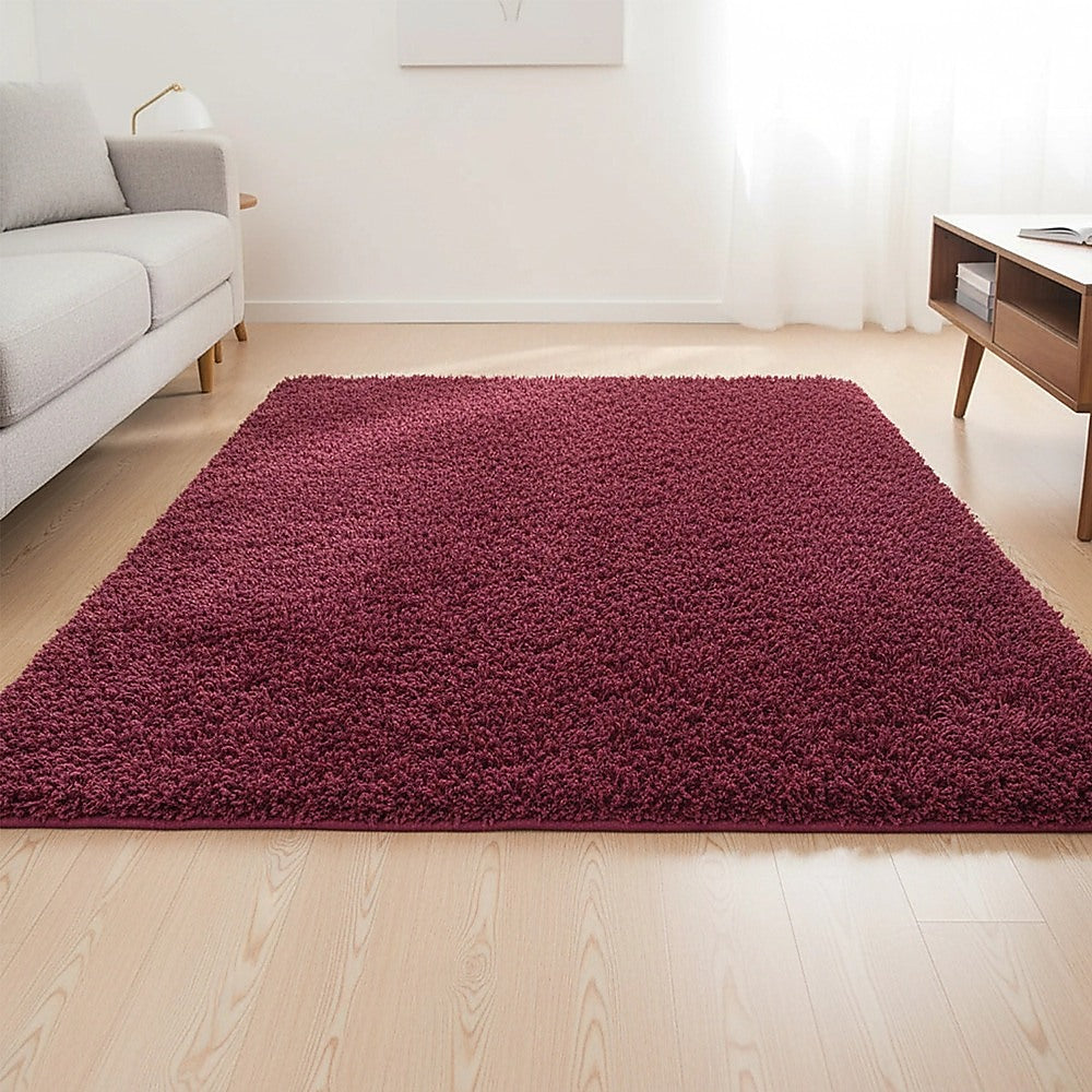 Burgundy shaggy area rug with dense high pile, rectangular shape