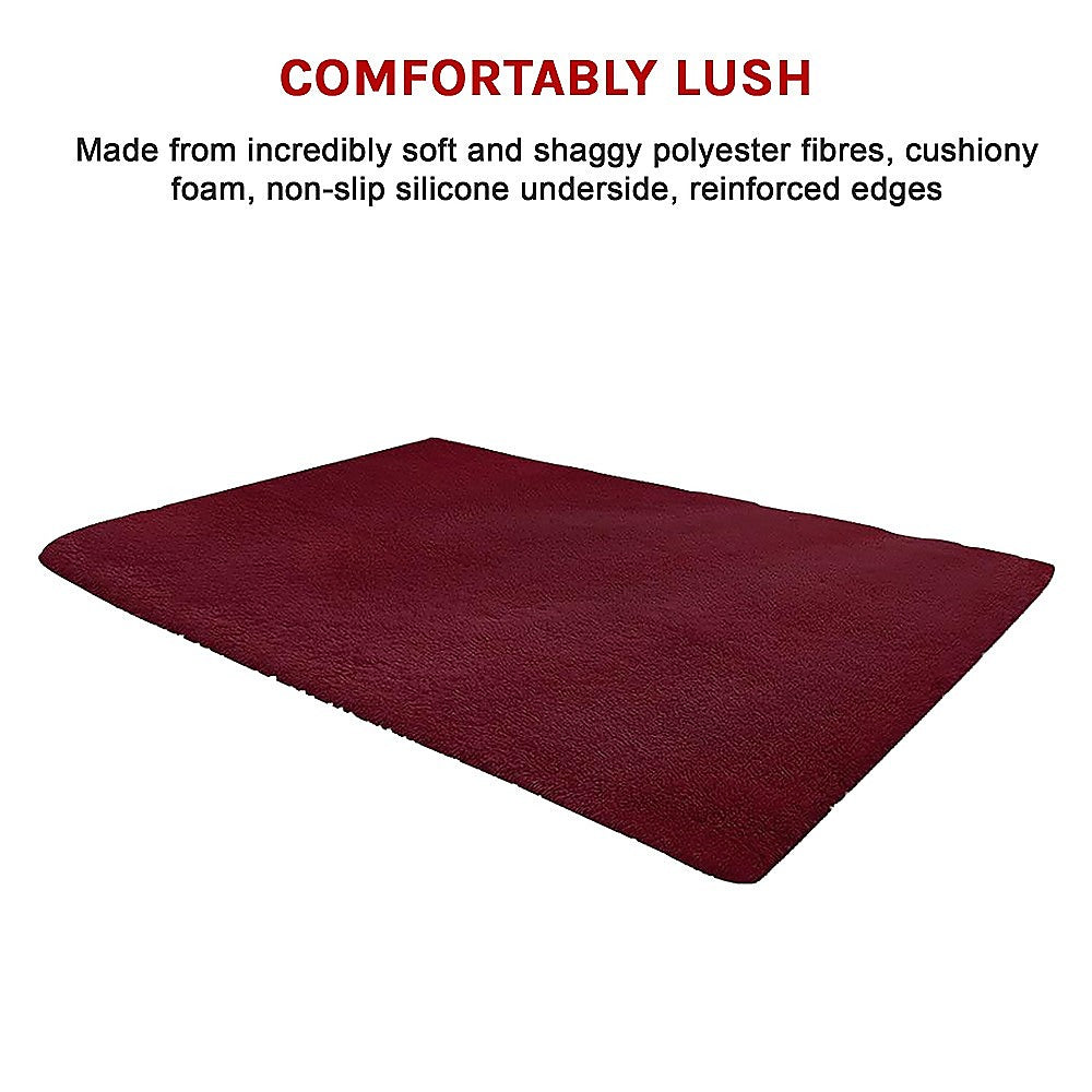 Burgundy shaggy area rug, smooth rectangle with dense pile and stitched edges