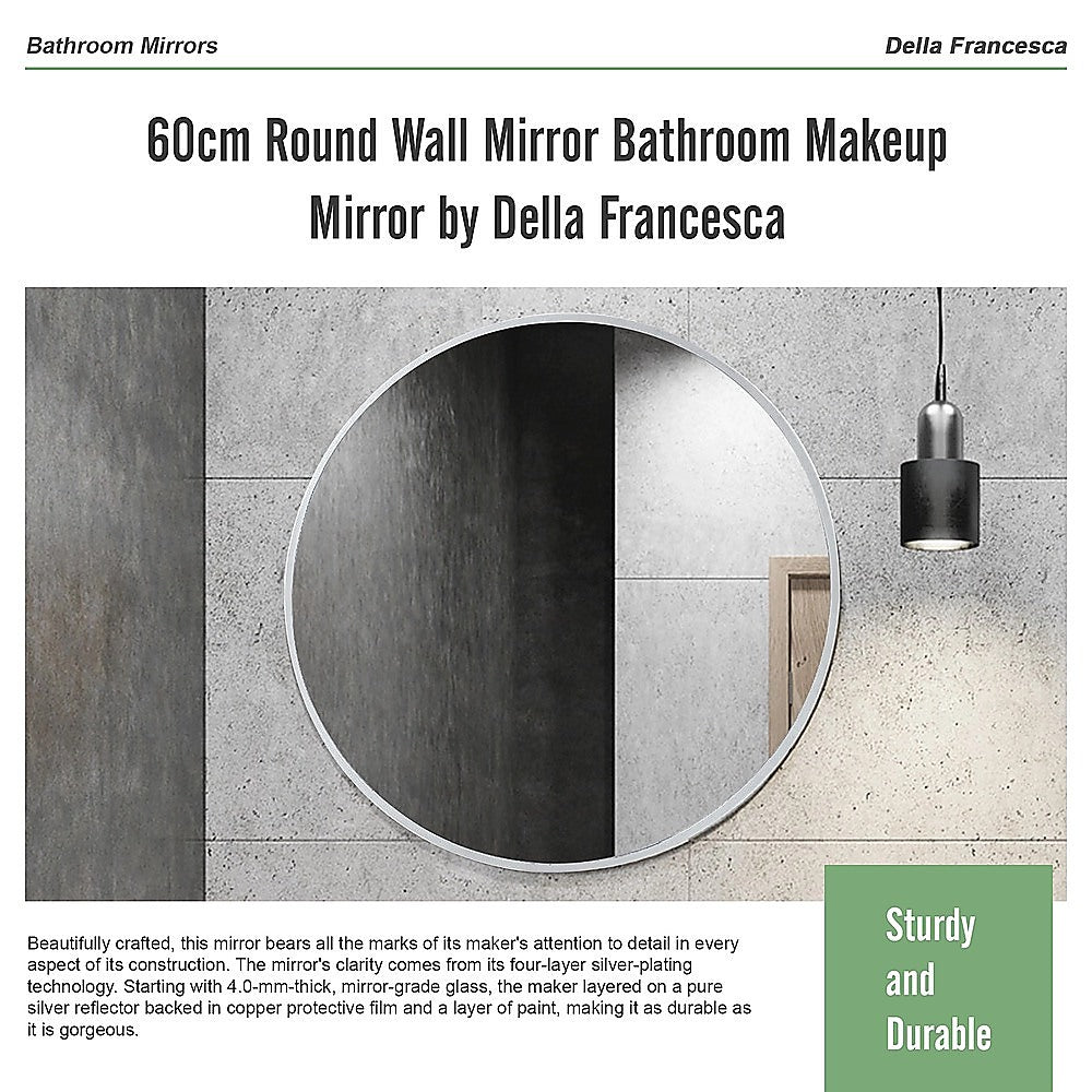 Round wall mirror with white frame above a bathroom sink