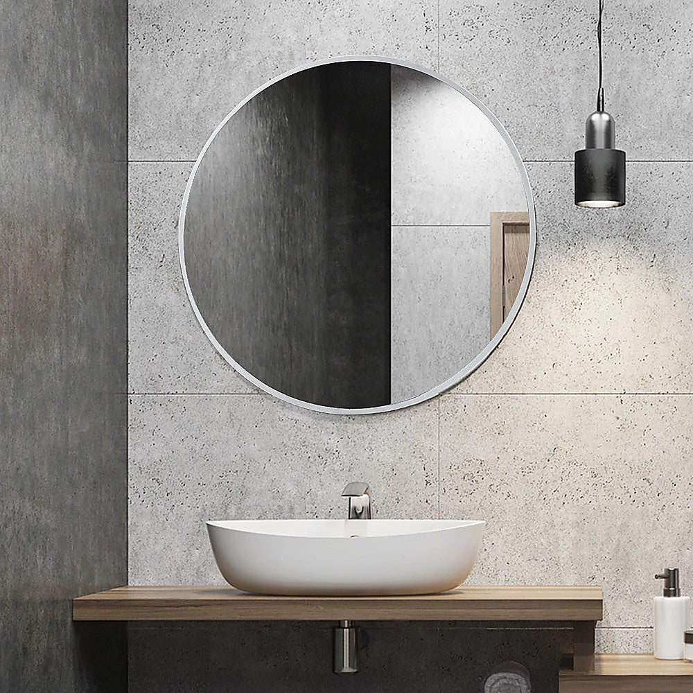 Round wall mirror with silver-tone frame and reflective center