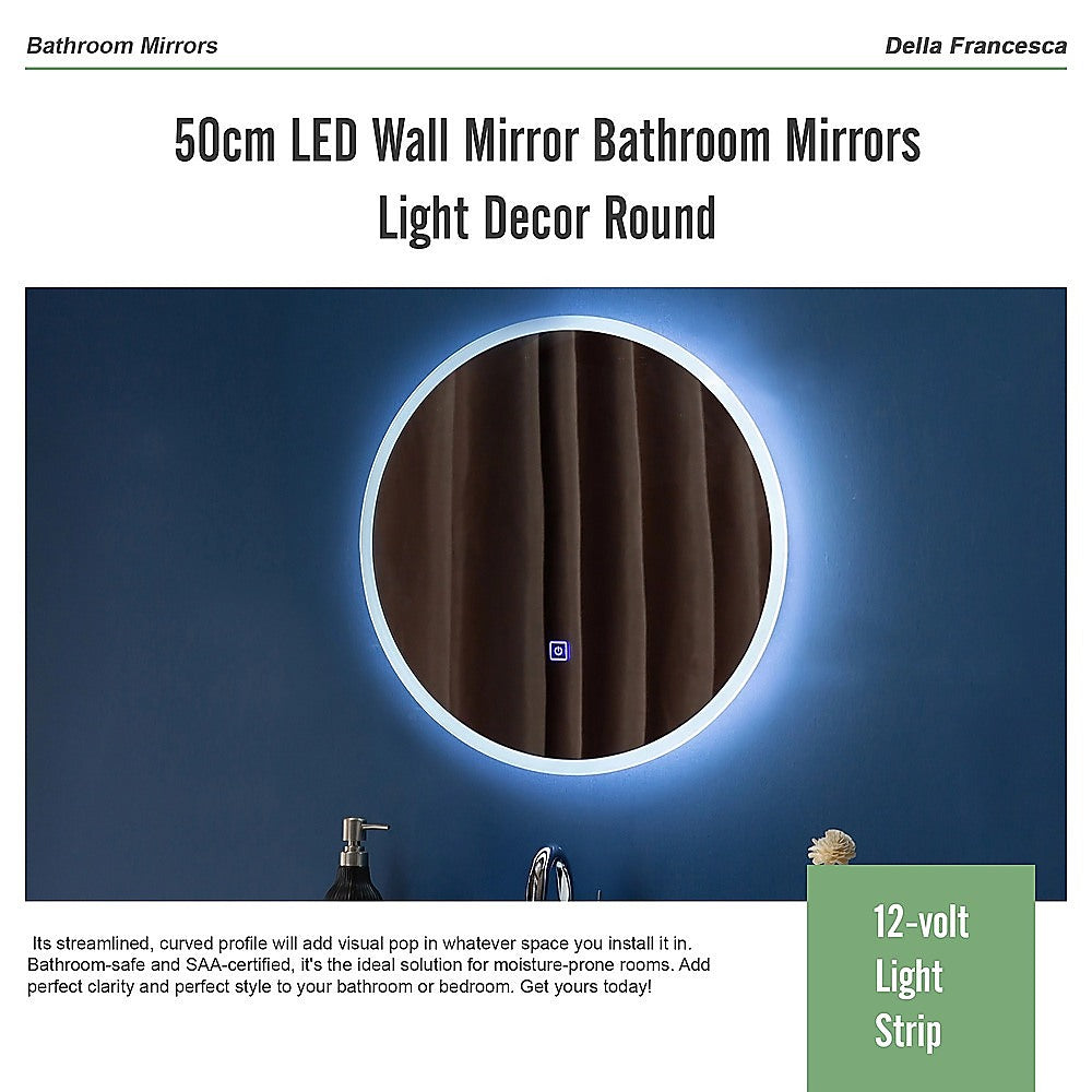 Round LED wall mirror with bright light ring and silver rim mounted in a bathroom