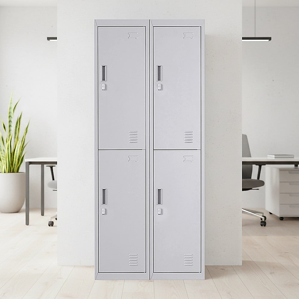 Four-door steel storage locker with two pairs of doors, light gray, standing on floor indoors.