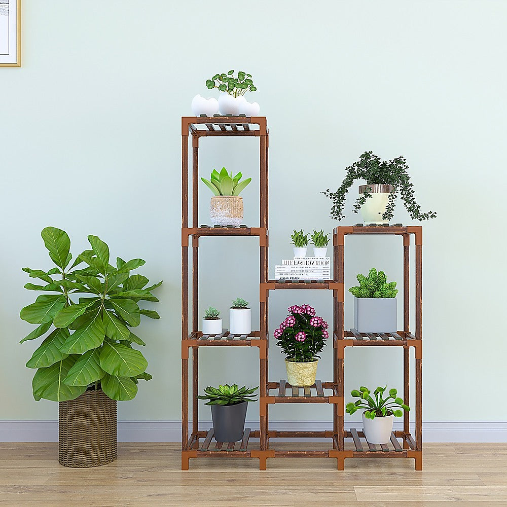 Wooden plant stand with 9 shelves displaying assorted potted plants