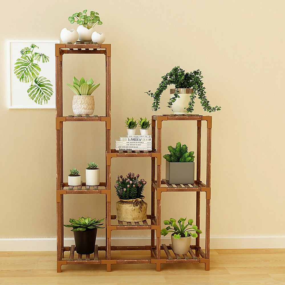 Wooden plant stand with 9 shelves featuring potted plants on each tier