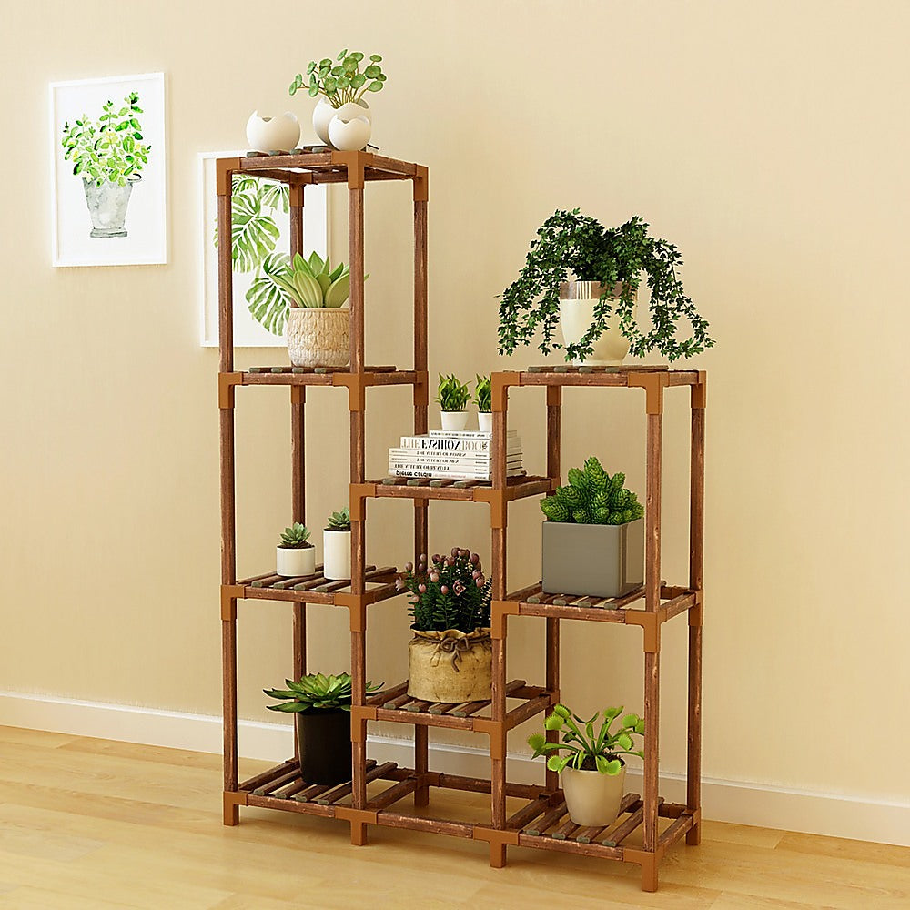 Wooden plant stand with 9 shelves displaying several potted plants