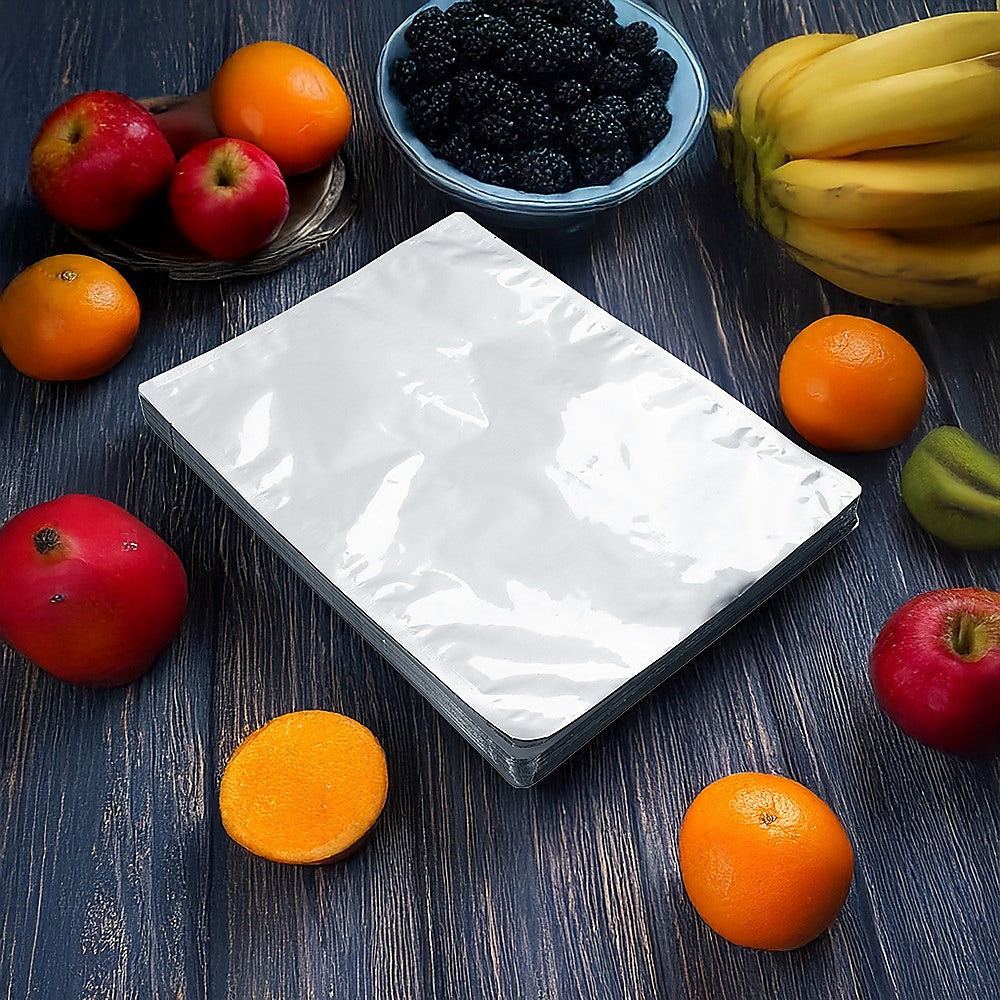 Silver vacuum storage bag pouch on tabletop, open heat-seal edge visible.