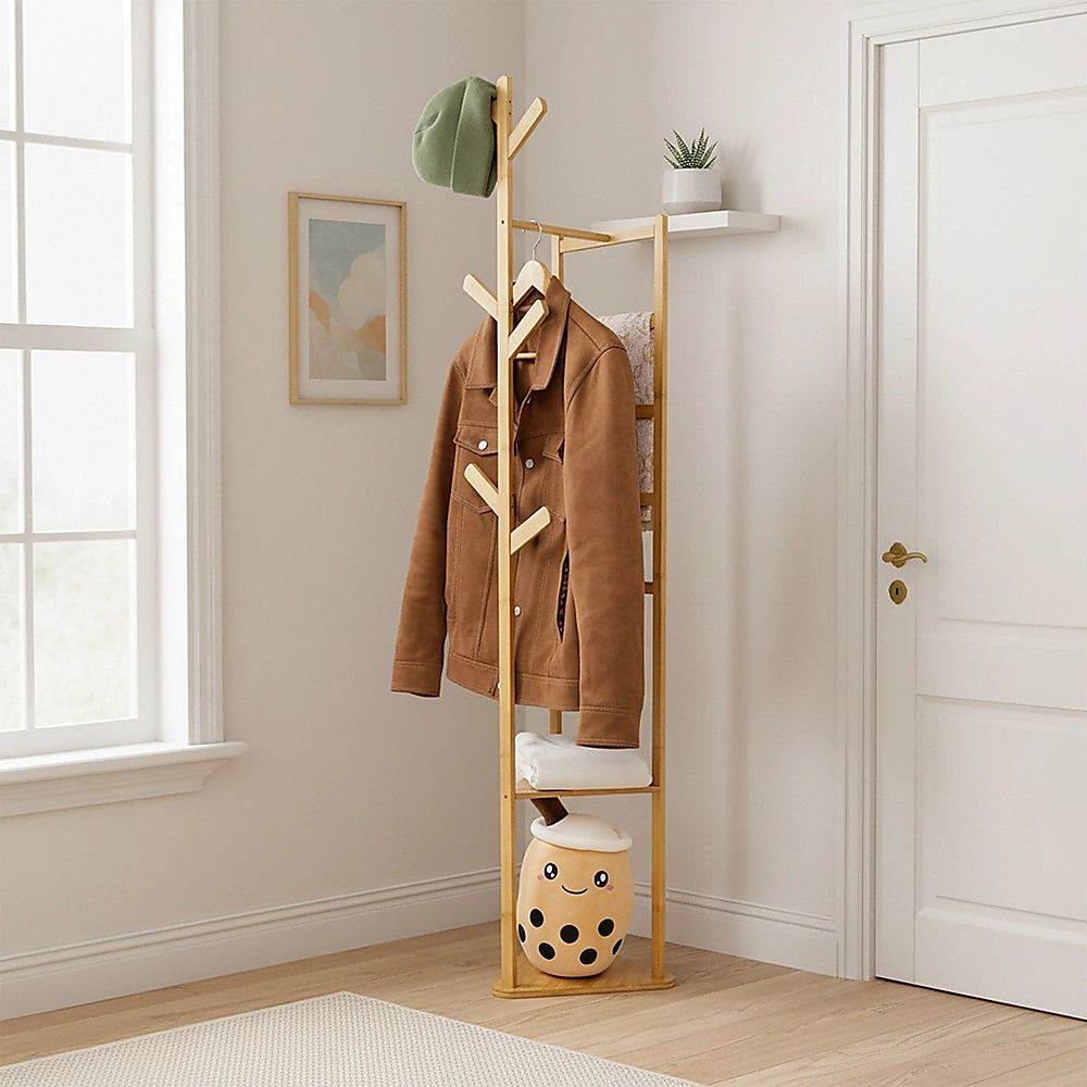 Wooden coat rack with hanging coat, cap, and top shelf