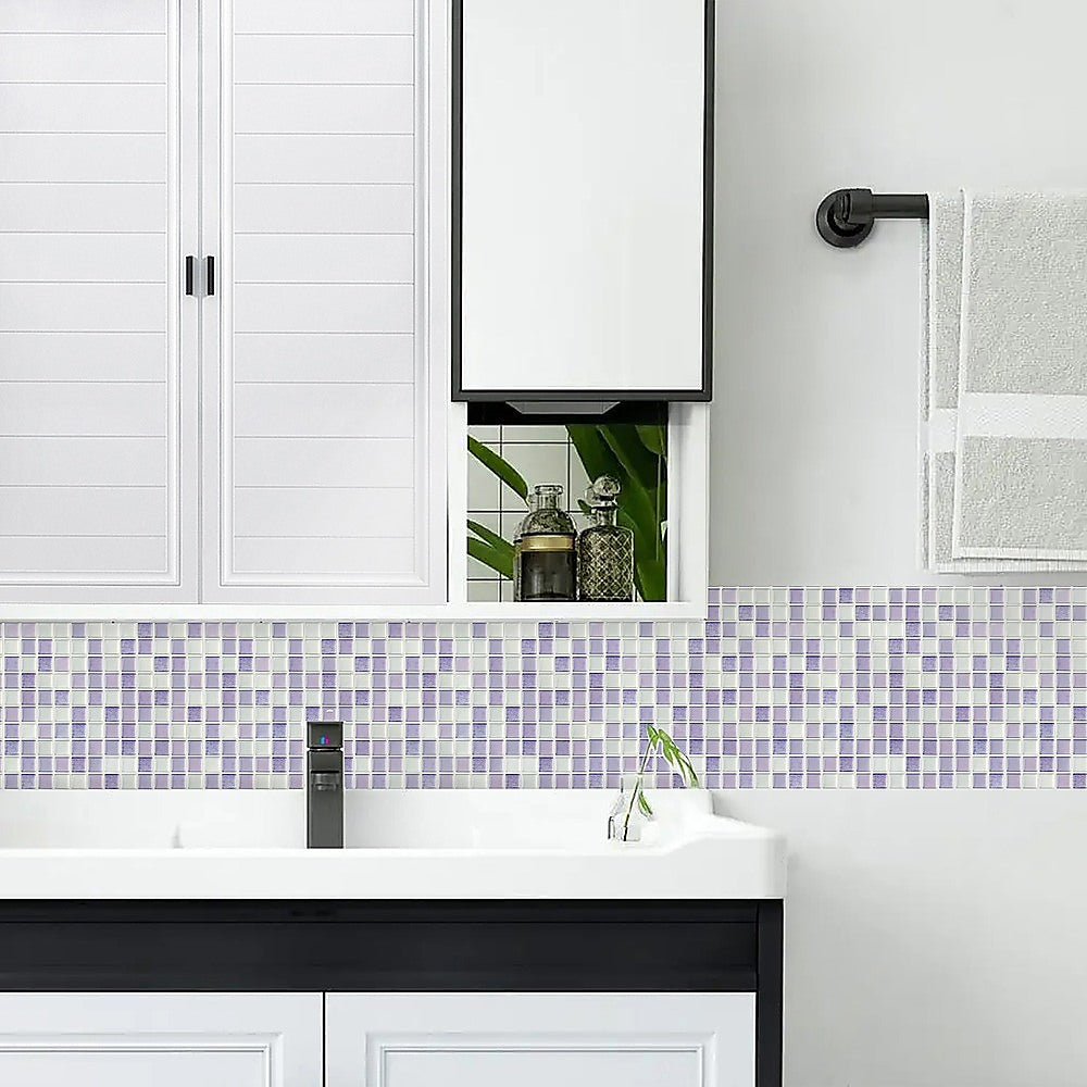Pastel purple and light blue mosaic wall tile strip above a white sink and vanity