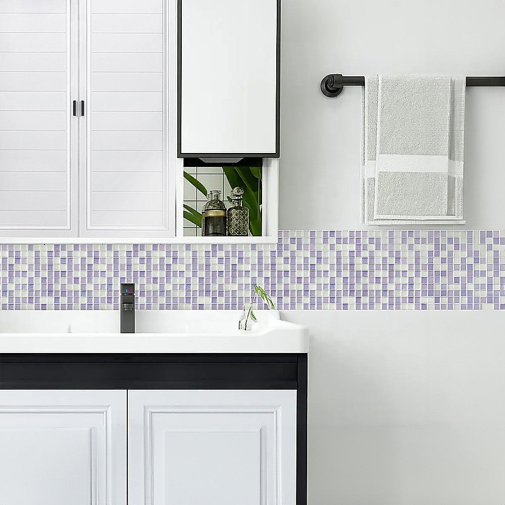 Pastel purple and pale blue mosaic wall tile strip beside a white vanity and sink