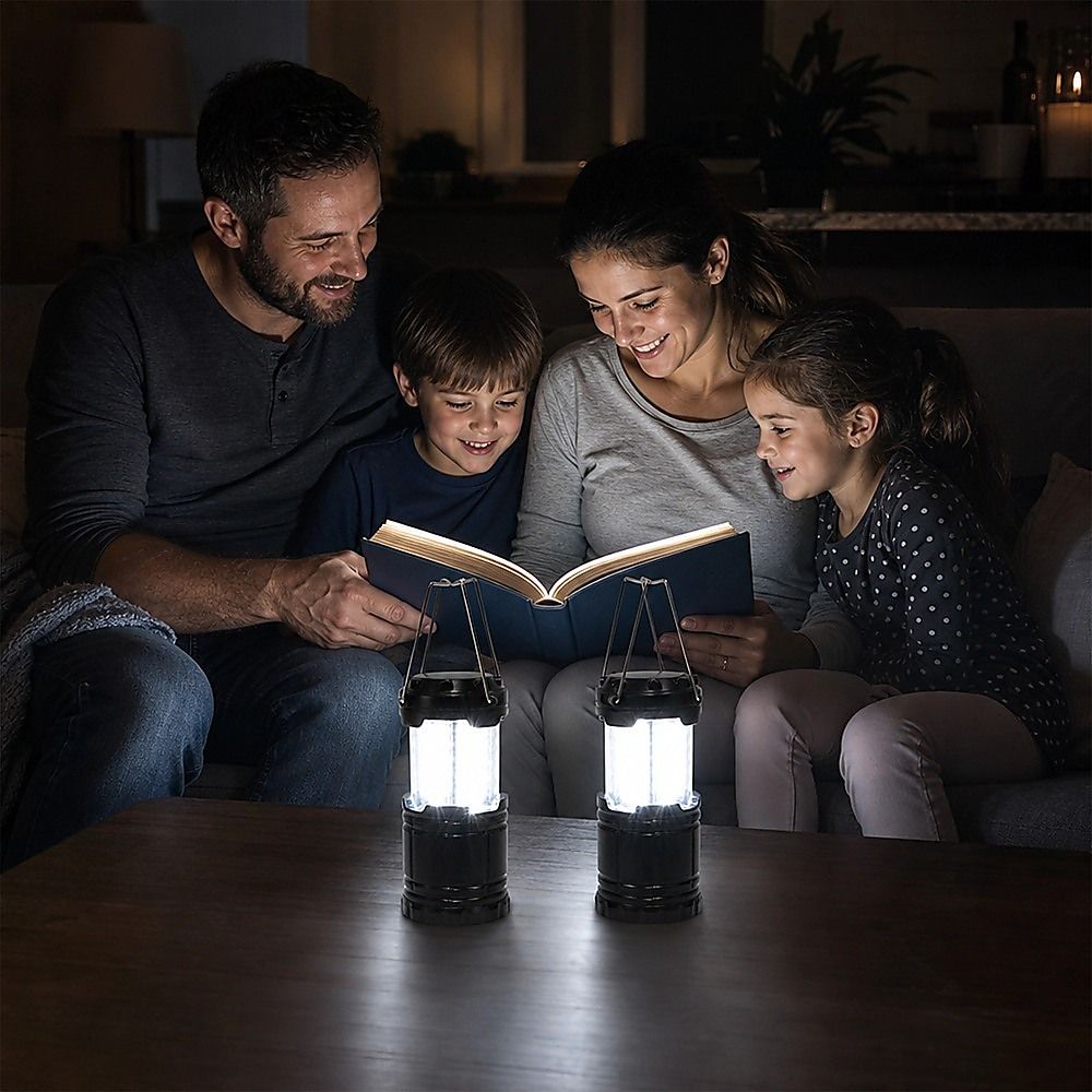 LED camping lanterns on floor table, black bodies with clear LED panels and handles