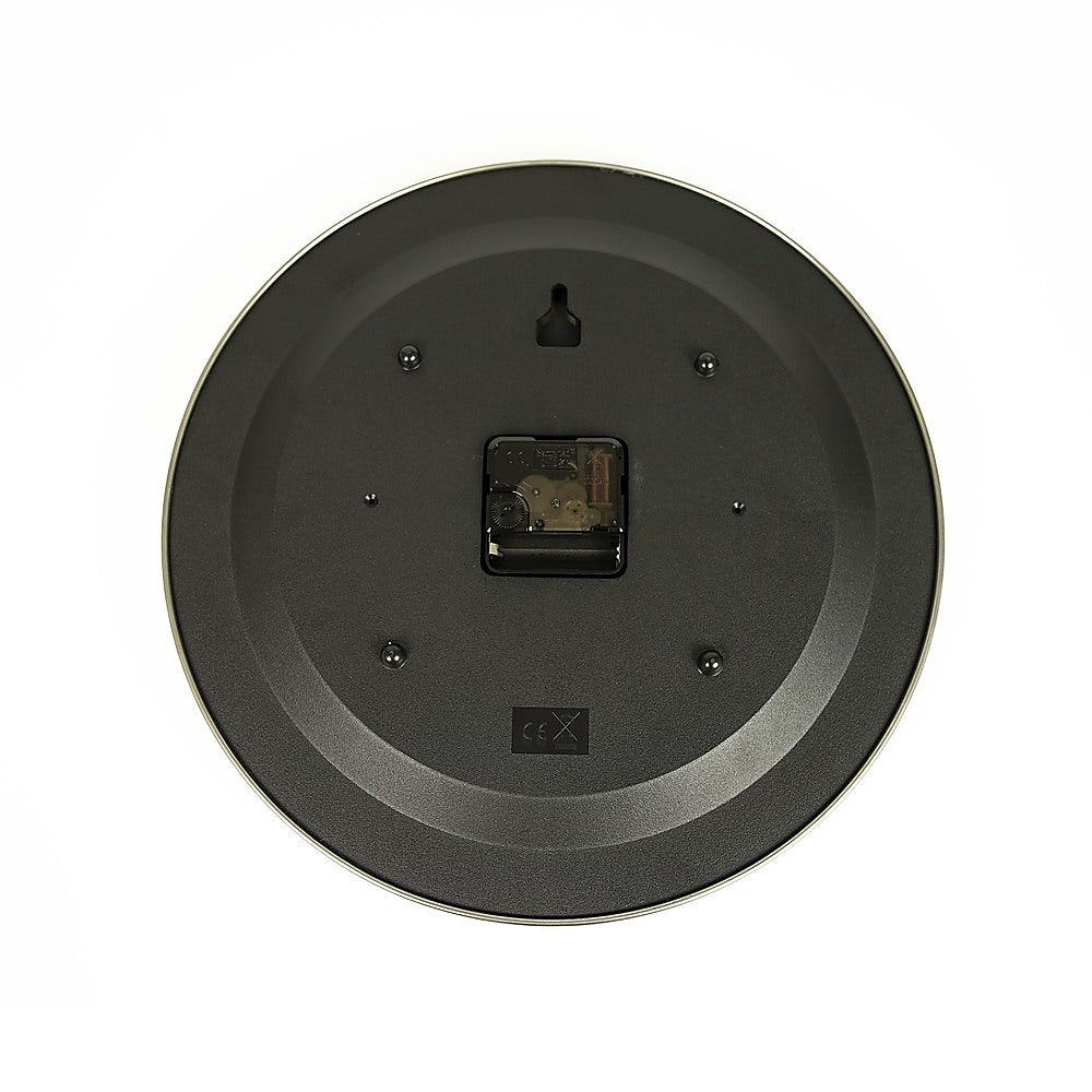 Back view of round wall clock with black housing and battery compartment