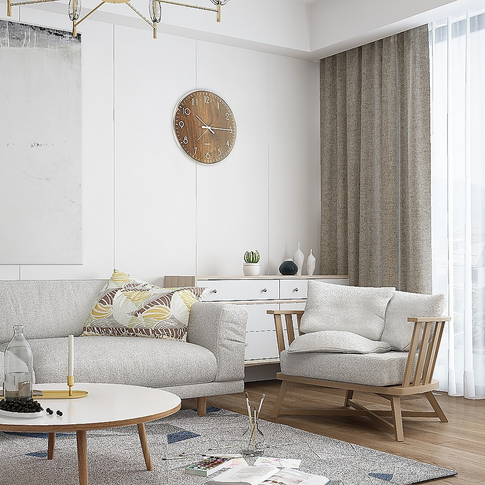 Round wood-grain wall clock on interior wall, white numerals and slim hands