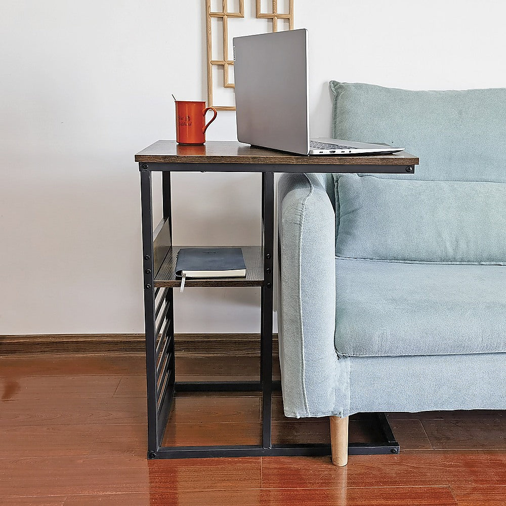 Side end table with wood top, dark metal frame, and open lower shelf beside sofa
