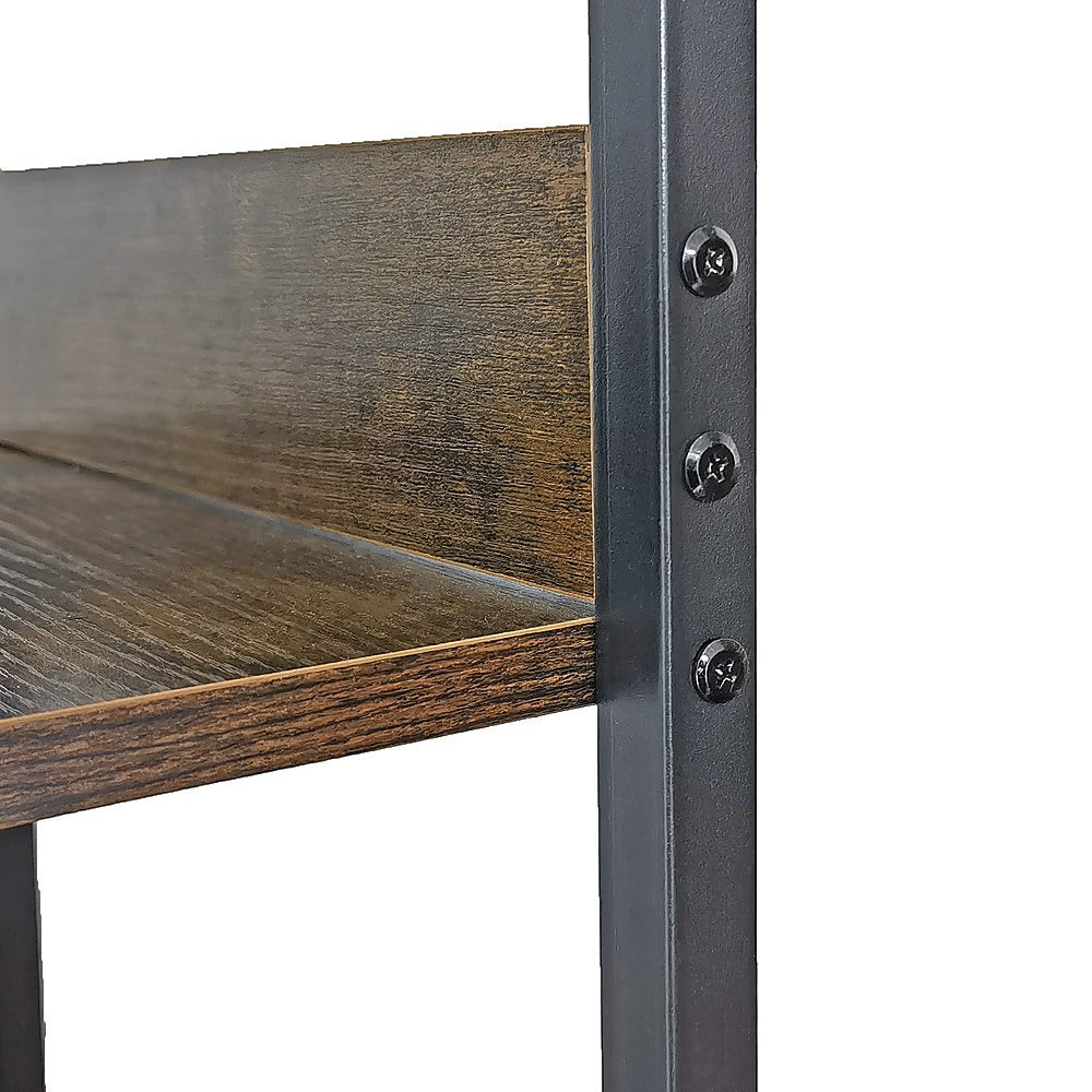 Wood shelf panel and dark metal table leg with round screws at corner
