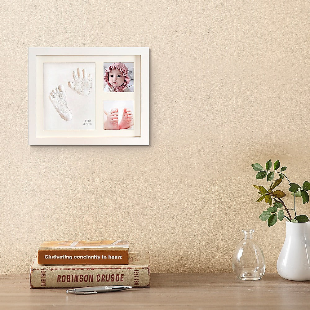 White photo frame with baby hand and foot clay prints and two photo slots