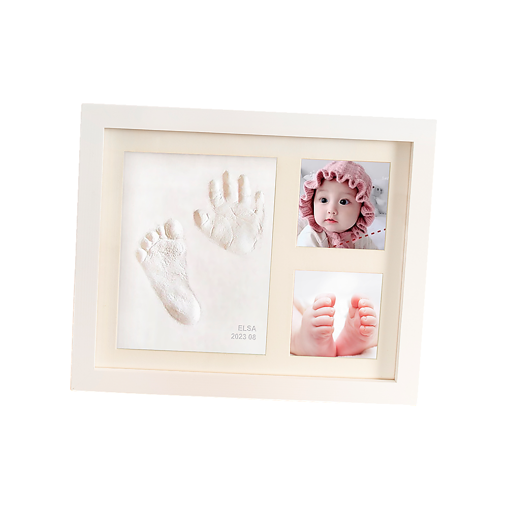 White photo frame holding baby hand and foot clay prints with two inset photos