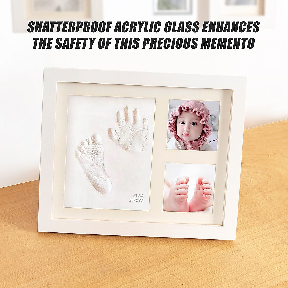 White photo frame showing baby hand and foot clay prints plus two inset baby photos