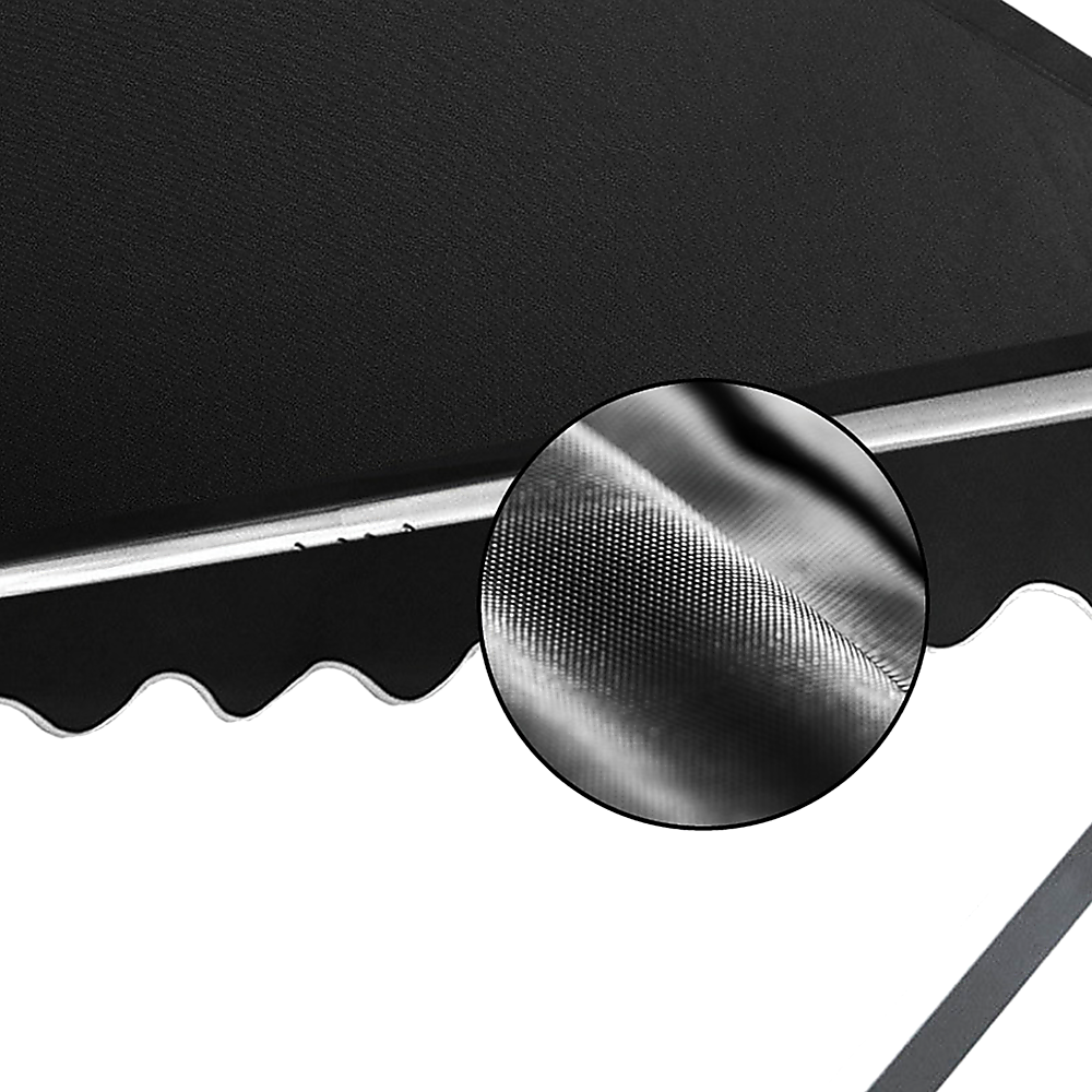 Close-up of black awning fabric with scalloped valance and metal support bar