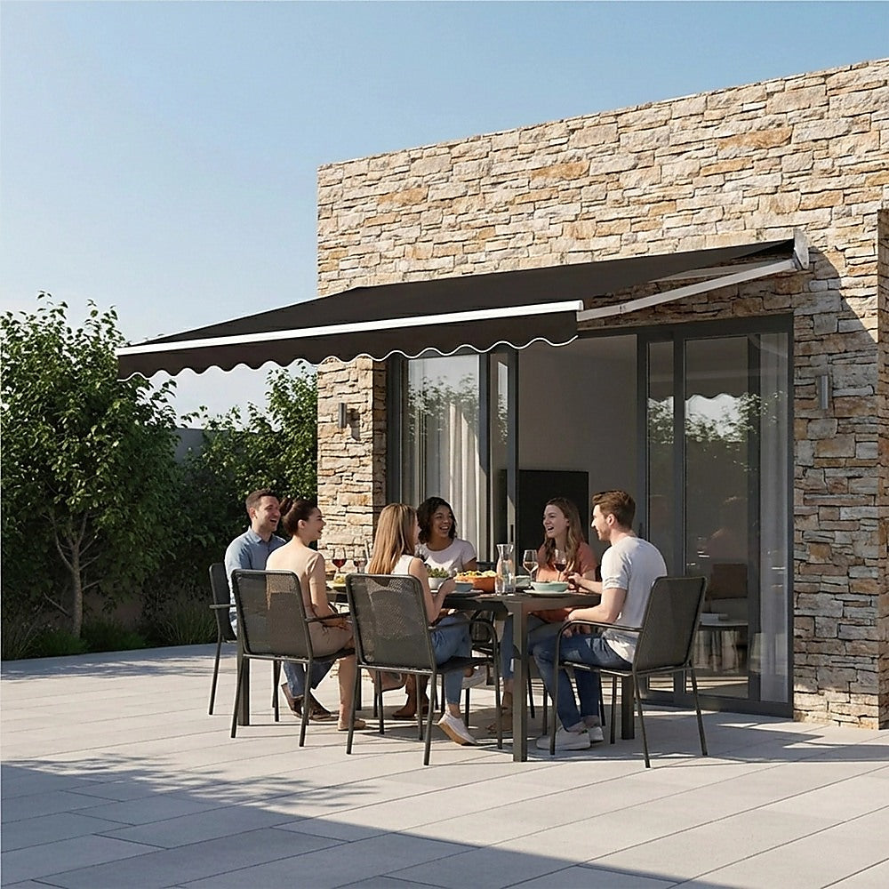 Motorized retractable awning with black canopy above stone building window