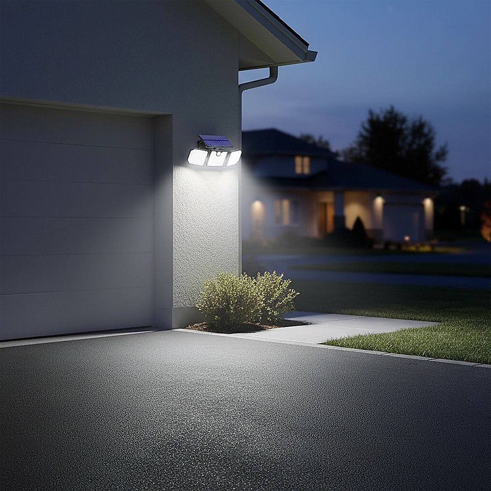Solar LED wall light with three panels glowing beside a building entrance at night