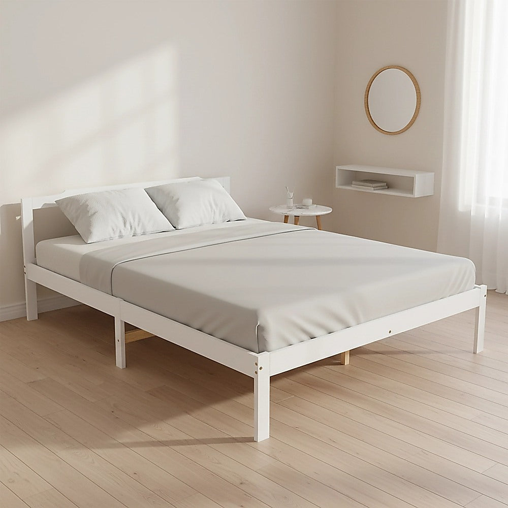 White double bed frame with mattress, pillows, and slatted base