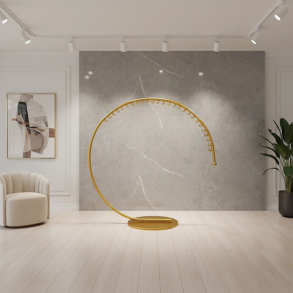 Curved floor clothes hanger rack with gold bar and round base plate