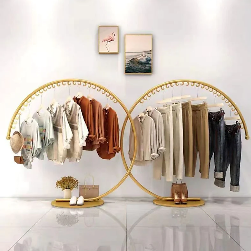 Double curved floor clothes hanger rack with gold rails and hanging shirts