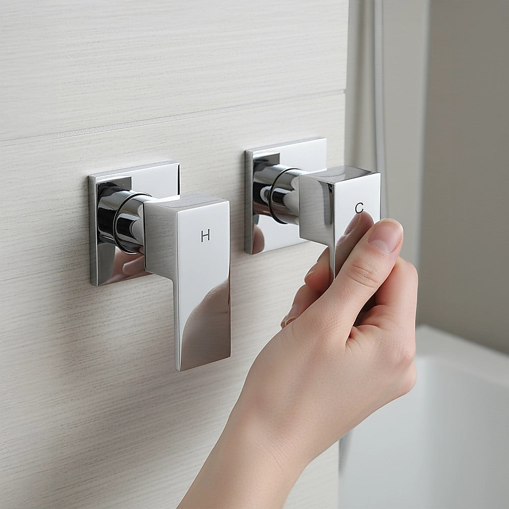 Wall-mounted square chrome mixer with H and C handles, hand turning control