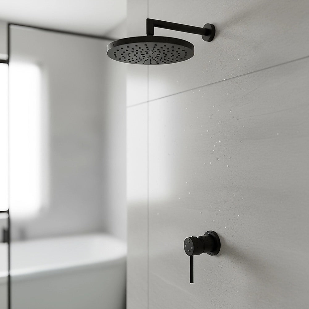 Matte black round shower bath mixer tap mounted on a bathroom wall