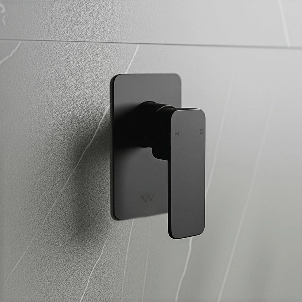 Black shower mixer tap on wall with square backplate and lever handle