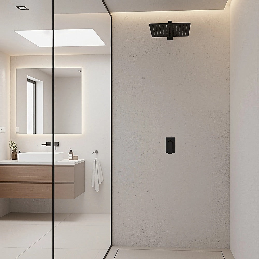 Black shower mixer tap with square backplate on bathroom wall