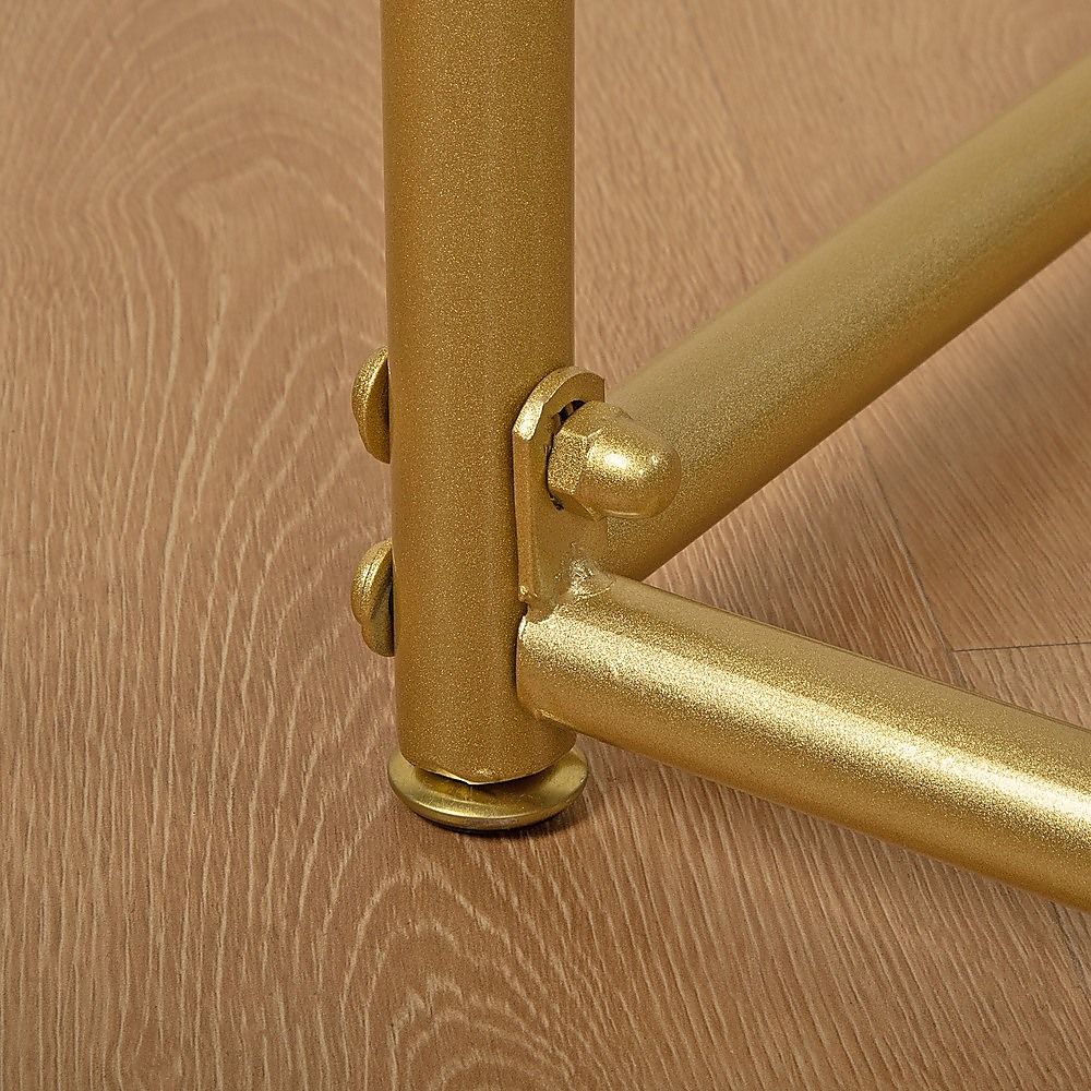 Gold metal rack bracket and tube connection with visible screws