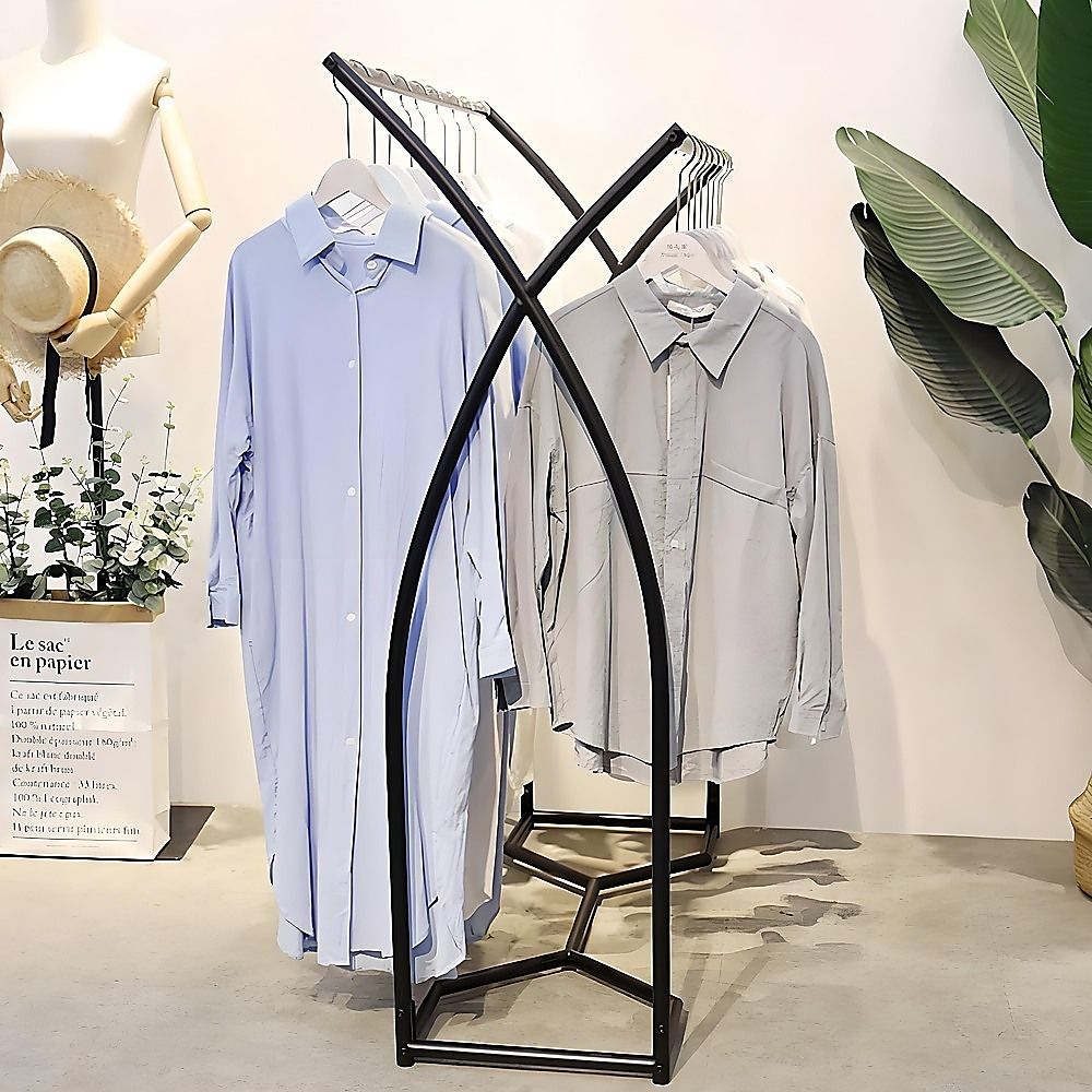 Black garment rack displaying shirts on hangers across the top bar