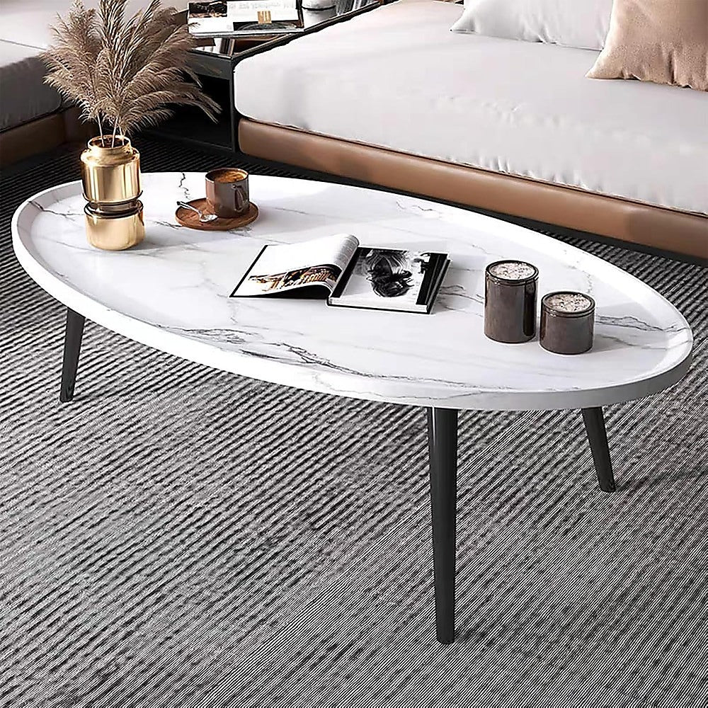 Oval marble-look coffee table with white top and black tapered legs