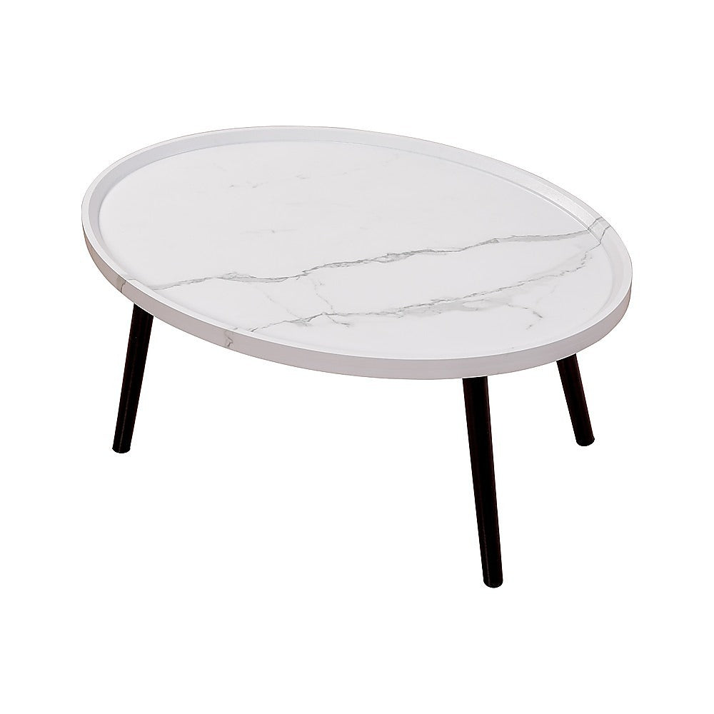 Oval marble-look coffee table with rounded white top and dark tapered legs