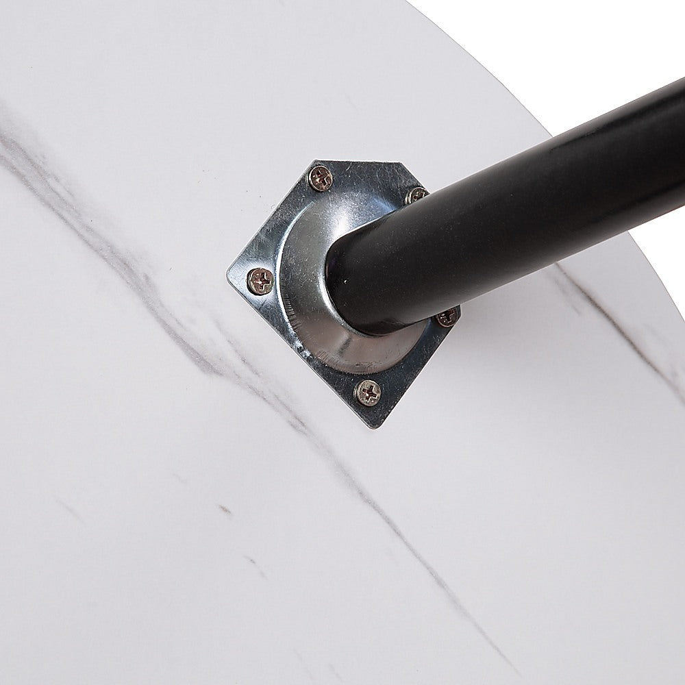 Coffee table leg bracket with black leg attached to white marble-look tabletop