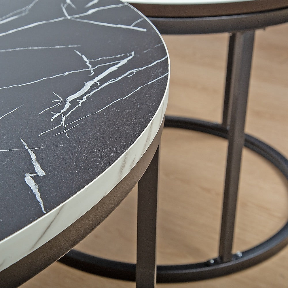 Round marble table top close-up with dark gray surface and white veining on black rim.