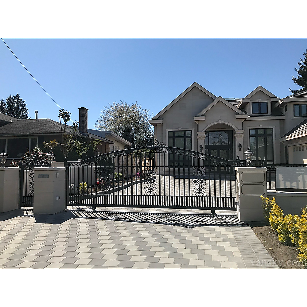 Sliding driveway gate with telescopic pulley track and rollers near gate posts