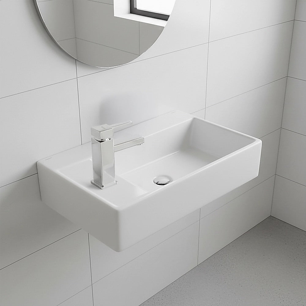 Wall-hung ceramic hand wash basin with drain and mixer tap, rectangular white bowl