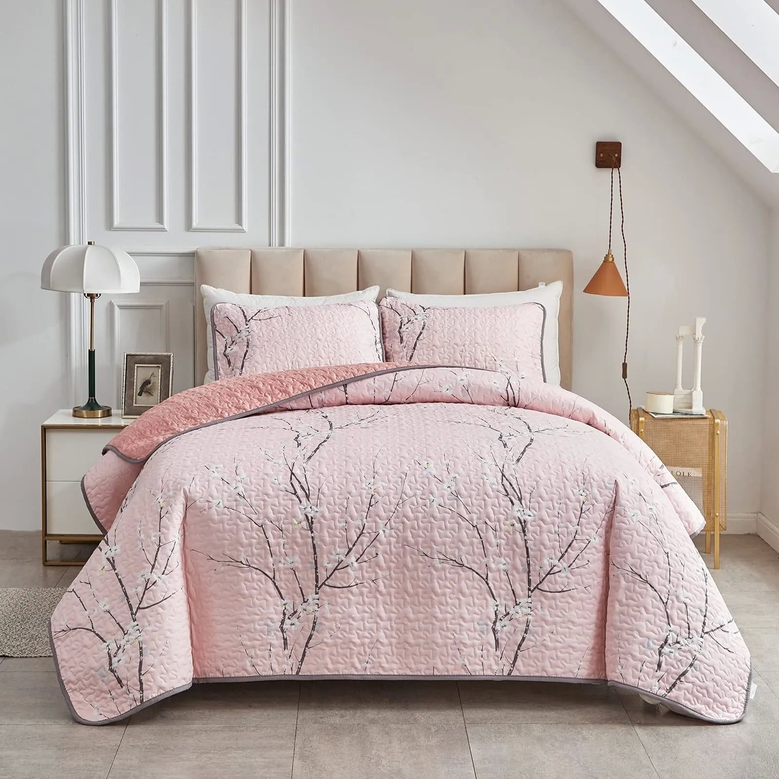 Quilted coverlet and pillowcase set in light pink with branch floral pattern