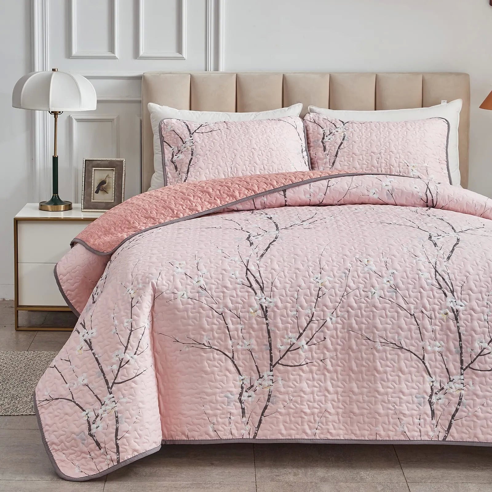 Quilted coverlet and matching pillowcases in light pink with branch print