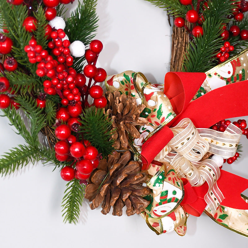Wreath close-up: pine branches, red berries, pinecones, and patterned ribbon bow