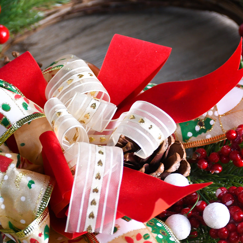 Wreath close-up of pinecones and red ribbon with gold-trimmed loops
