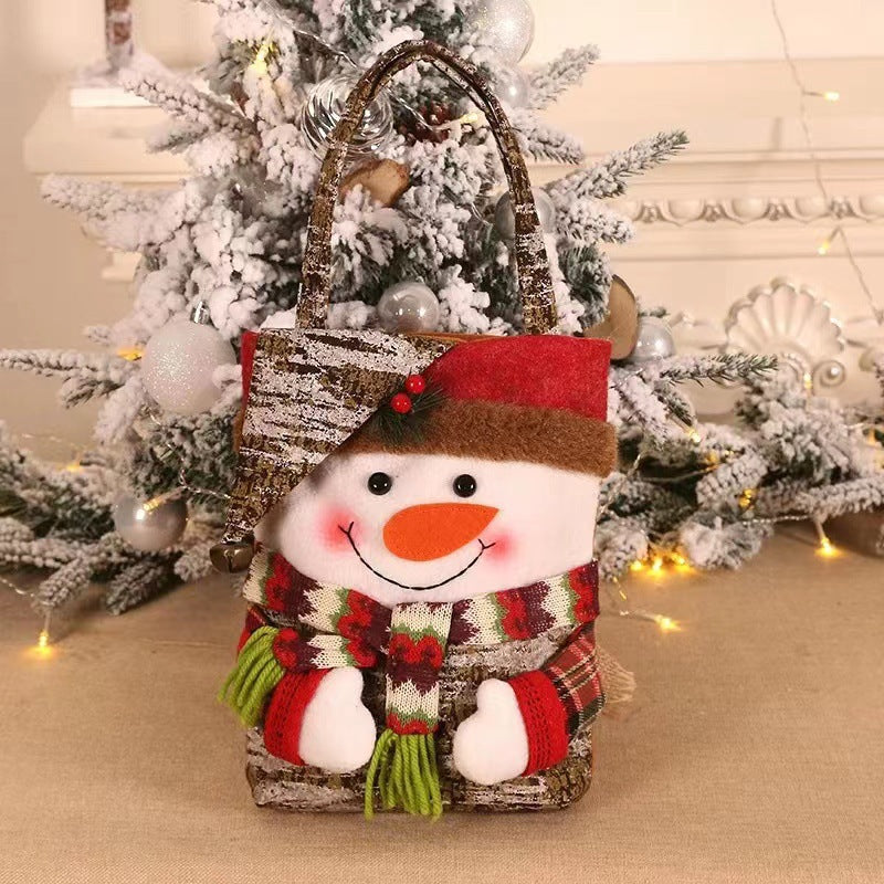 Snowman Christmas gift bag with red hat, orange nose, plaid scarf, and rope handle