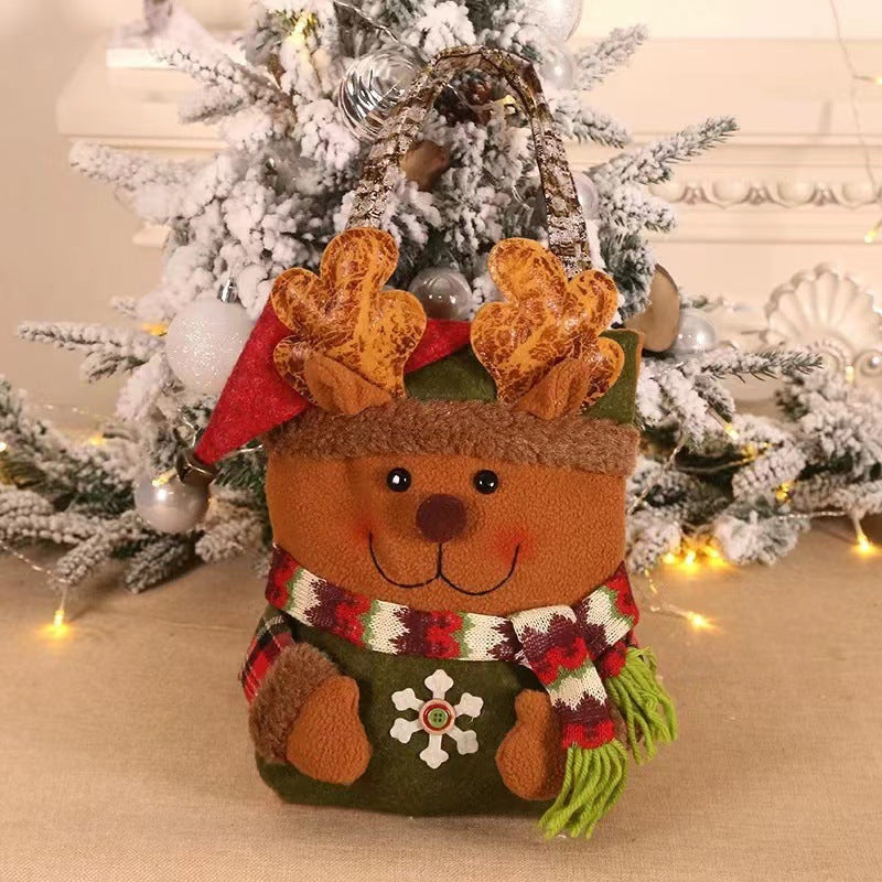 Reindeer Christmas gift bag with brown face, patterned body, green scarf, and rope handle